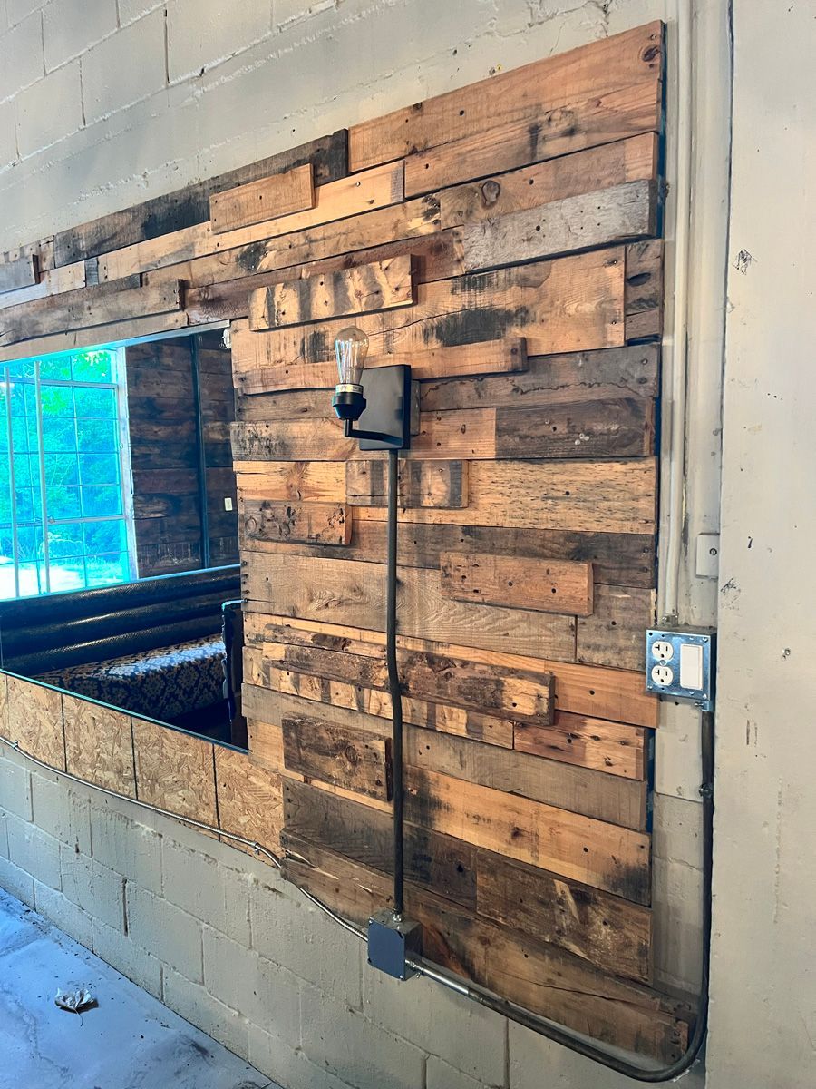 A wooden wall with a light on it in a room.