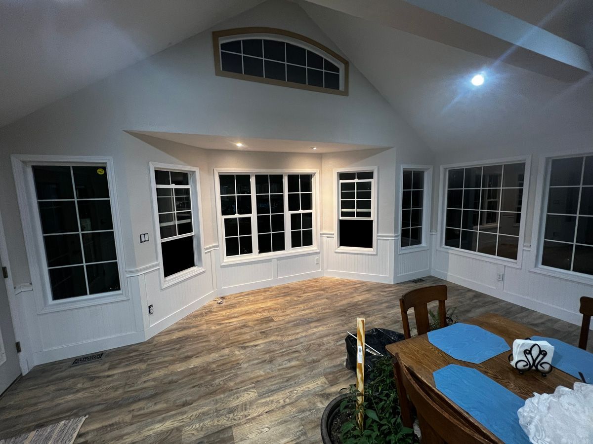 A large room with a dining table and chairs in it.