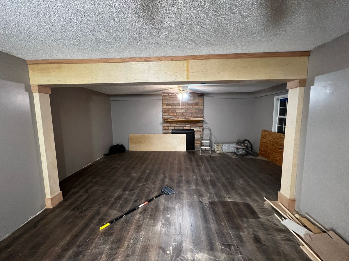 A living room with hardwood floors and a fireplace.