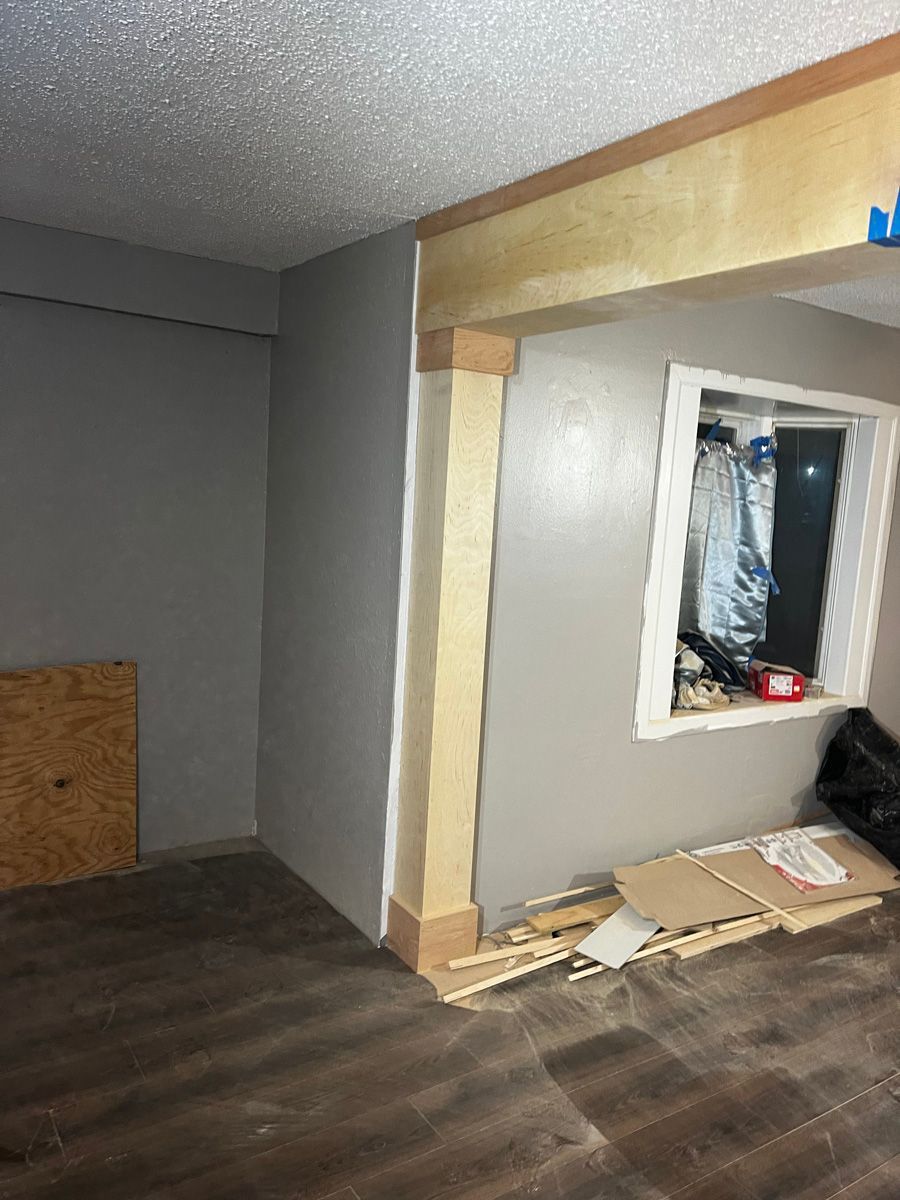 A room with a wooden floor and a window in it.