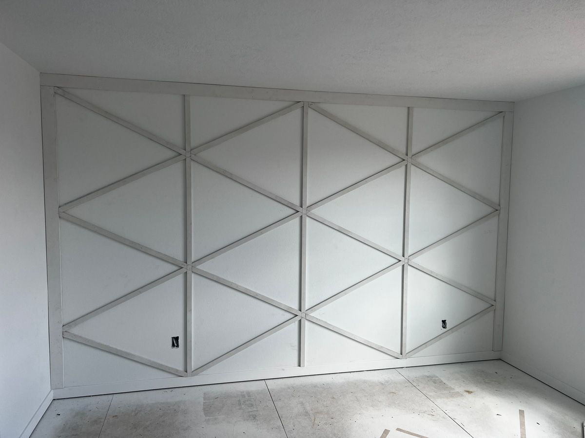 A white wall with a geometric pattern on it