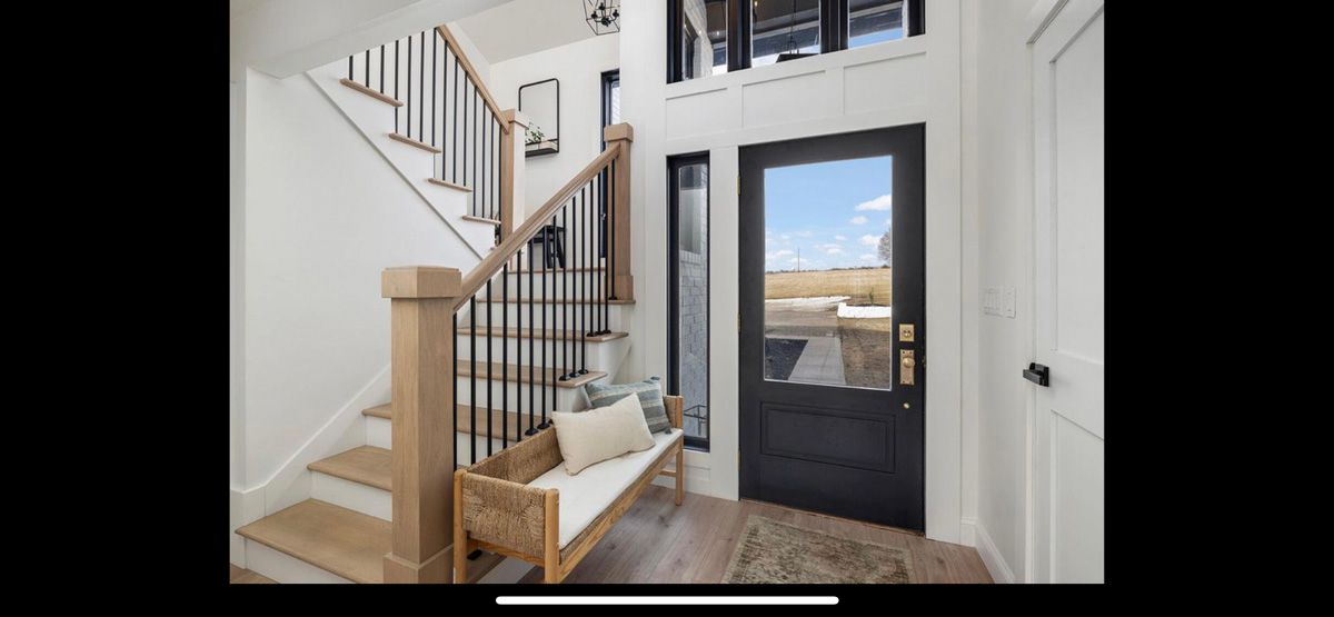 There is a bench in the middle of the hallway next to the stairs.
