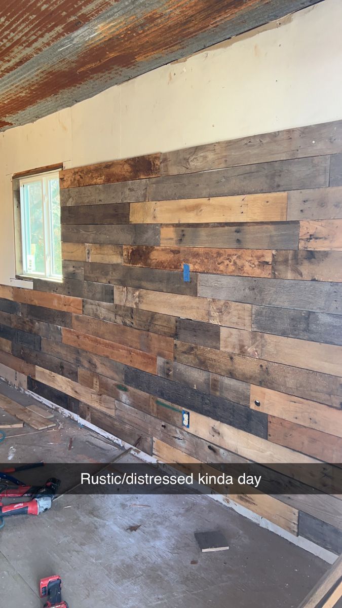 A room with a wooden wall and a window.
