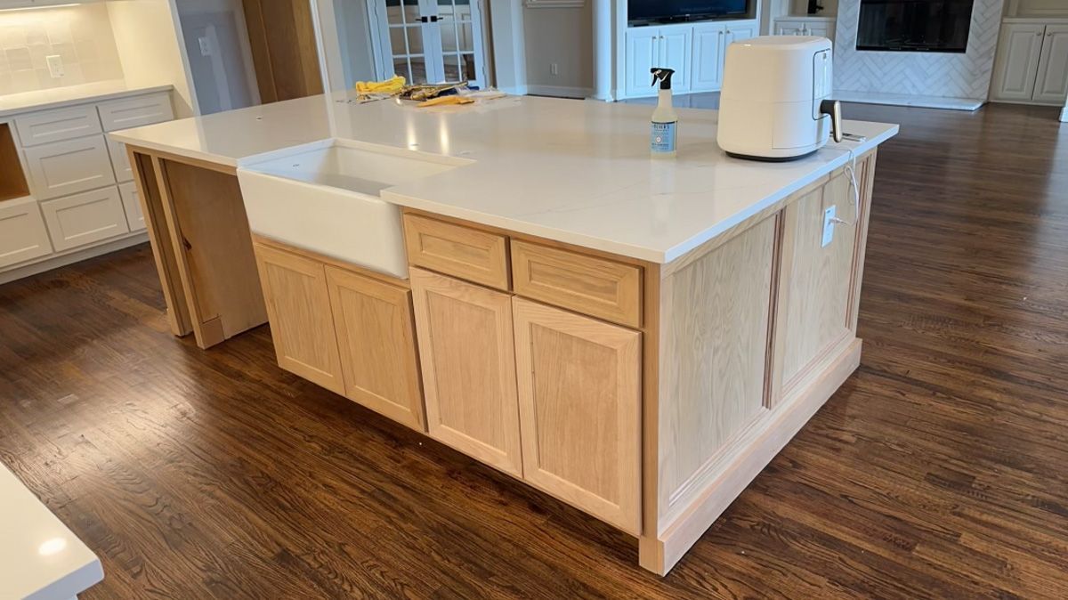 A kitchen island with a sink and a toaster oven on it.