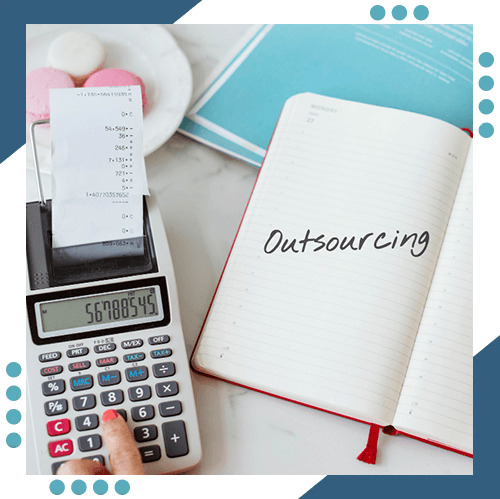 a person is using a calculator next to a notebook that says outsourcing .