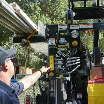 A man is standing in front of a large machine.