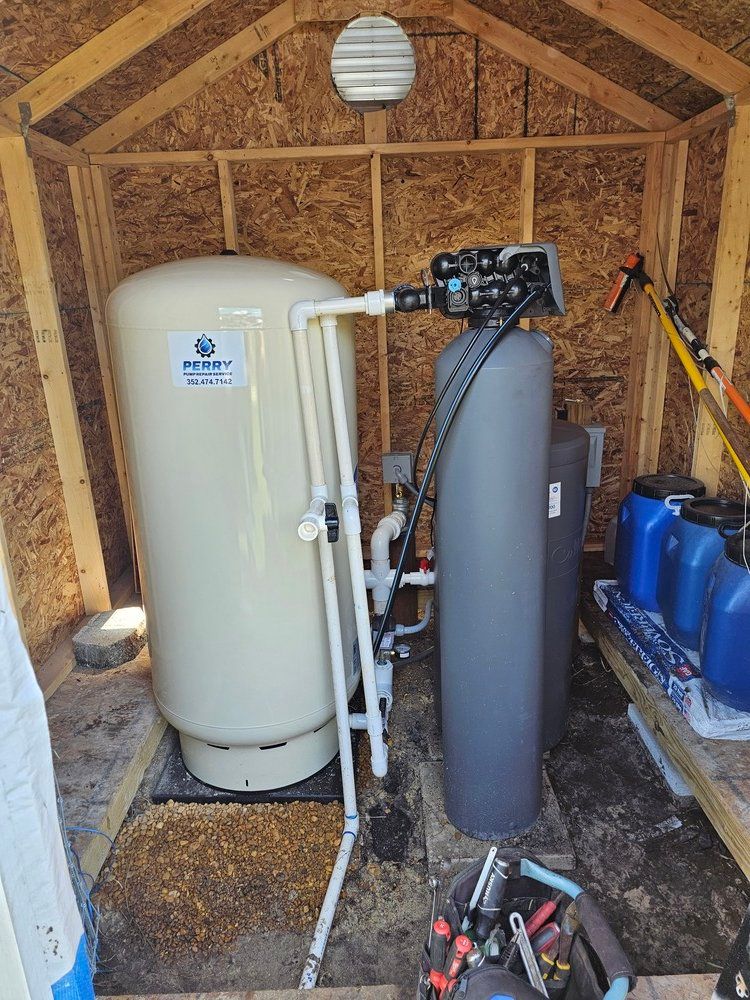 A water filter is sitting inside of a wooden shed.