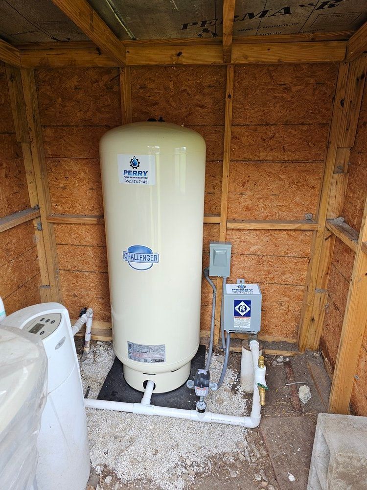 A water tank is sitting inside of a wooden shed.