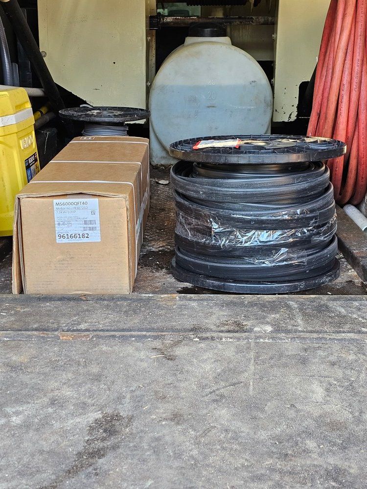 A stack of tires is sitting on the ground next to a box.