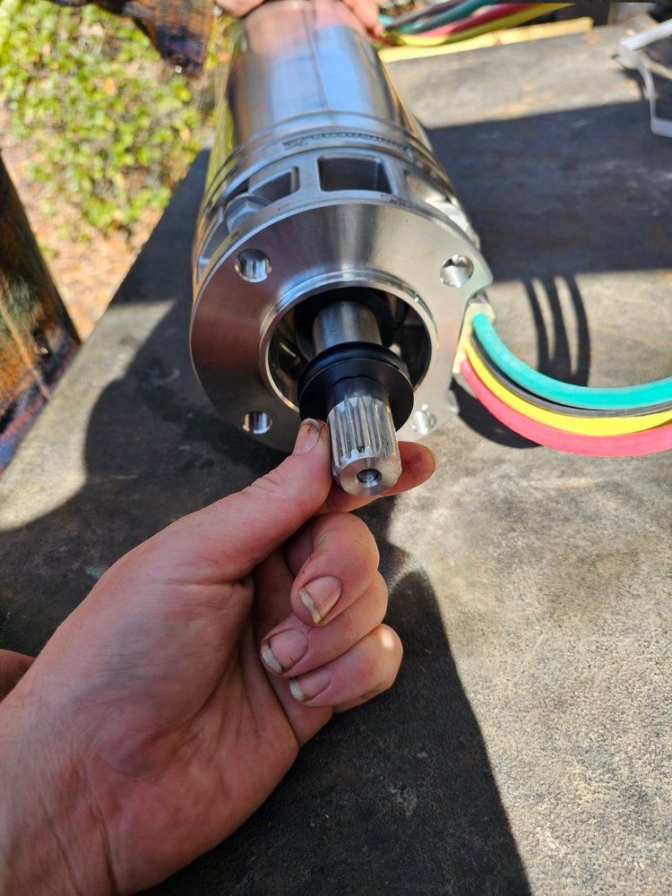 A person is holding a metal object in their hand.