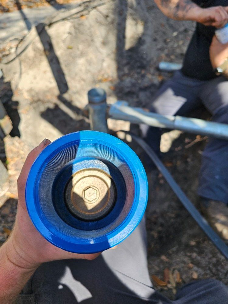 A person is holding a blue object in their hand.