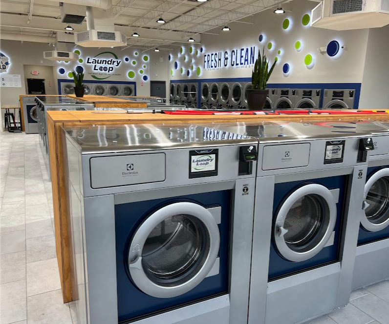 Laundry Loop washateria with industrial washing machines and Laundry Loop signage on the display