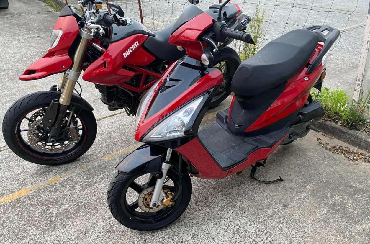 Two Motorcycles Are Parked Next to Each Other on the Side of the Road — Queensland Roadworthy Services In Southport, QLD