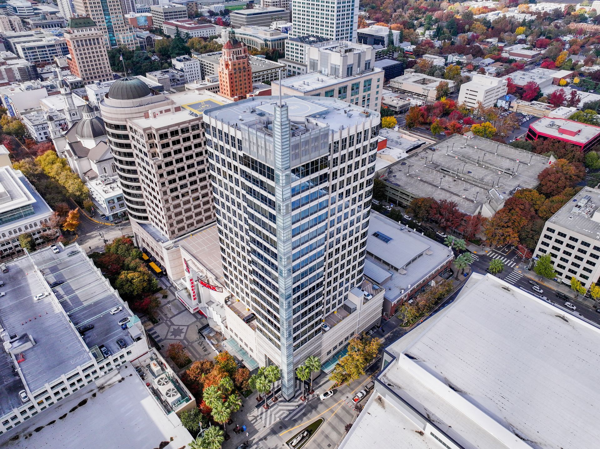 Aerial view of downtown buildings in Sacramento, California; a tall, modern skyscraper is prominent.