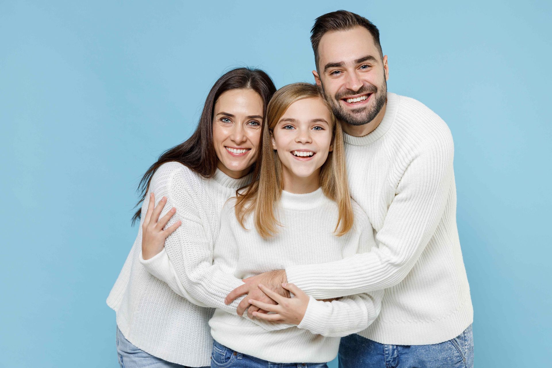 A family is hugging each other on a blue background