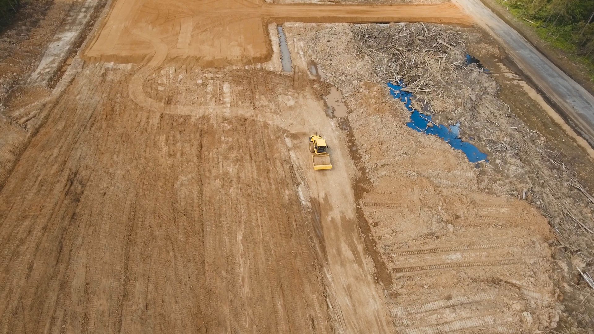 A bulldozer levels soil at a construction site.