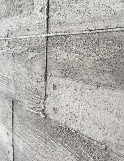A close up of a concrete wall that looks like wood.