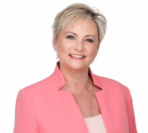Brenda Cassady Real Estate Specialist A woman in a pink jacket is smiling for the camera.