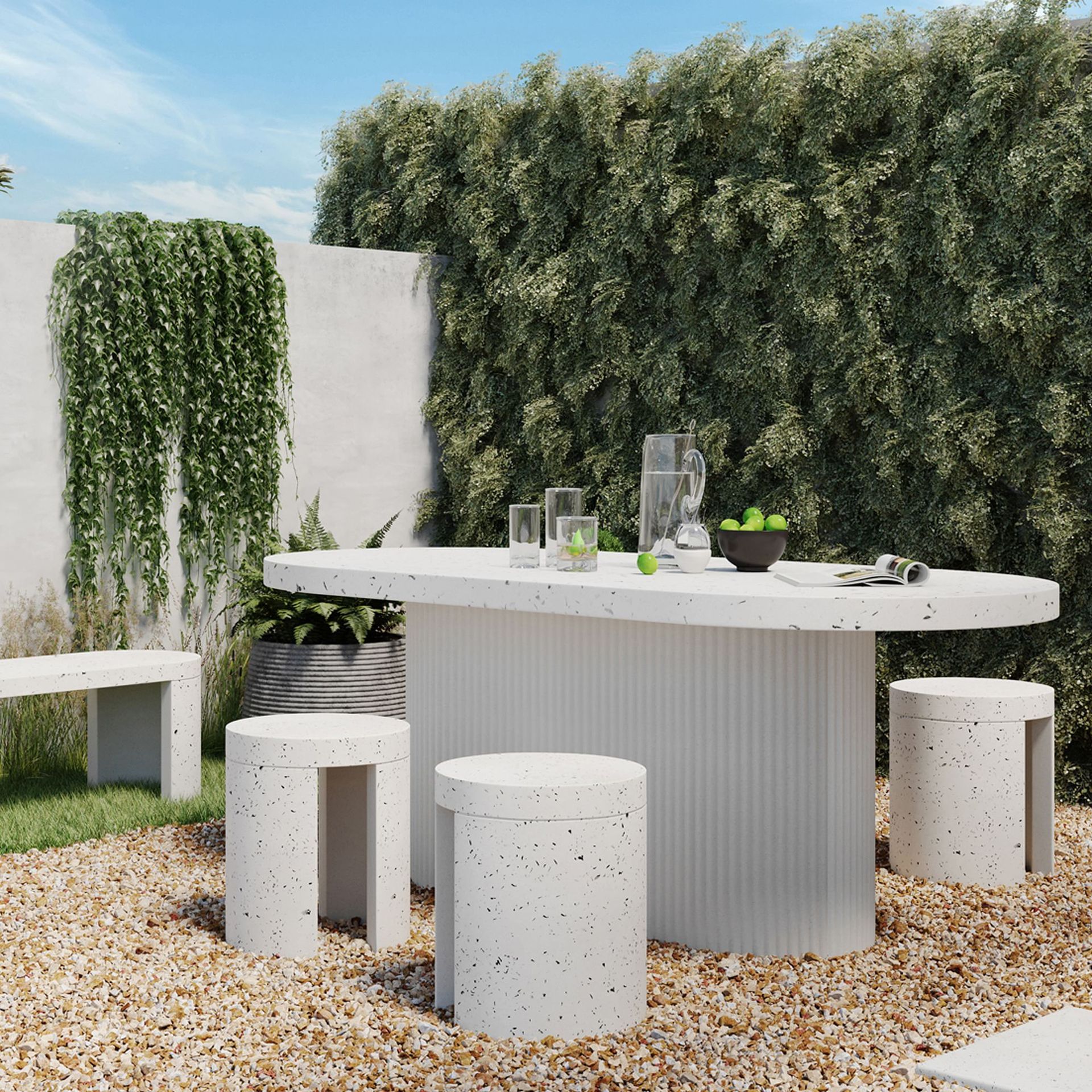 A white table and stools in a gravel area