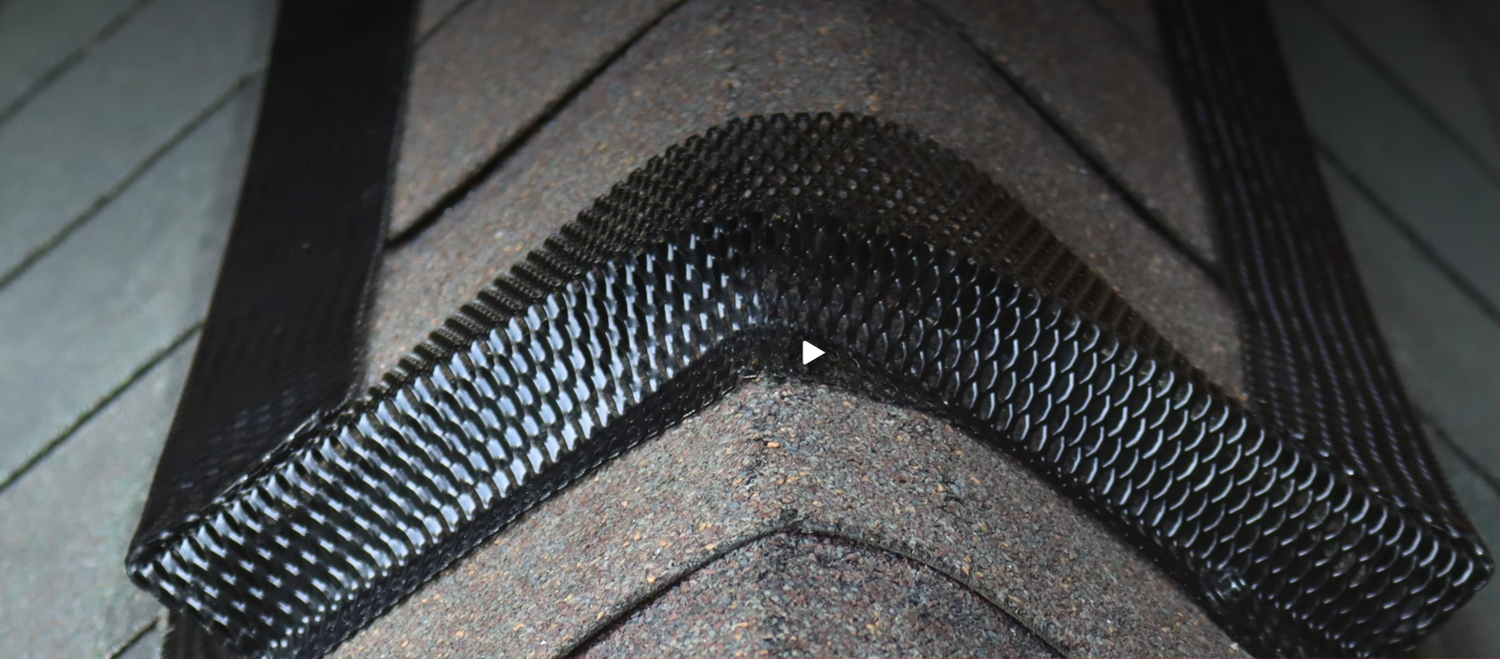 Close-up of a black textured fabric seam with a V-shaped fold and stitching detail