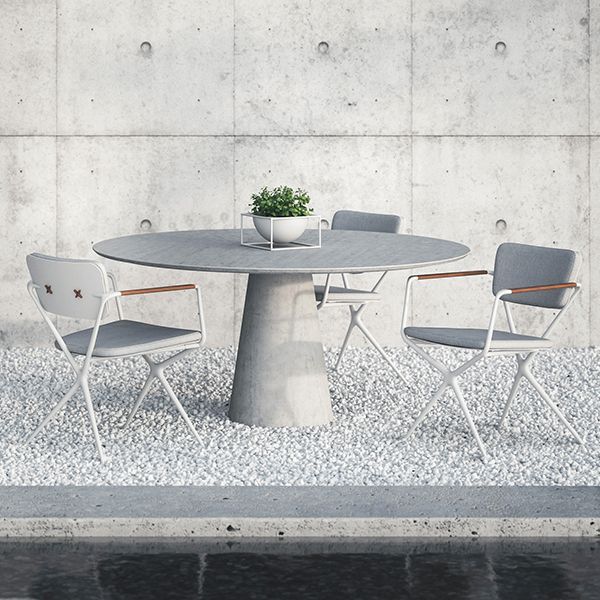 A round table with two chairs and a plant on it