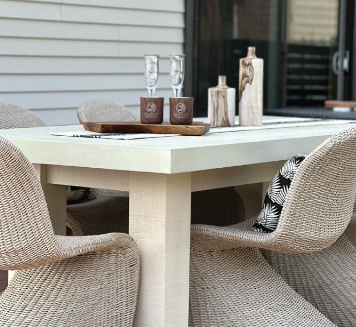 A table and chairs on a deck overlooking a lake