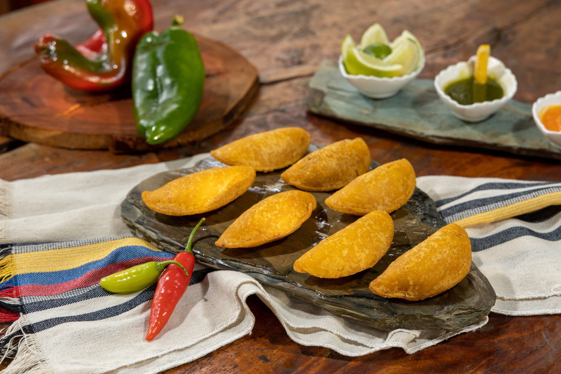 a wooden table topped with a tray of food and vegetables .