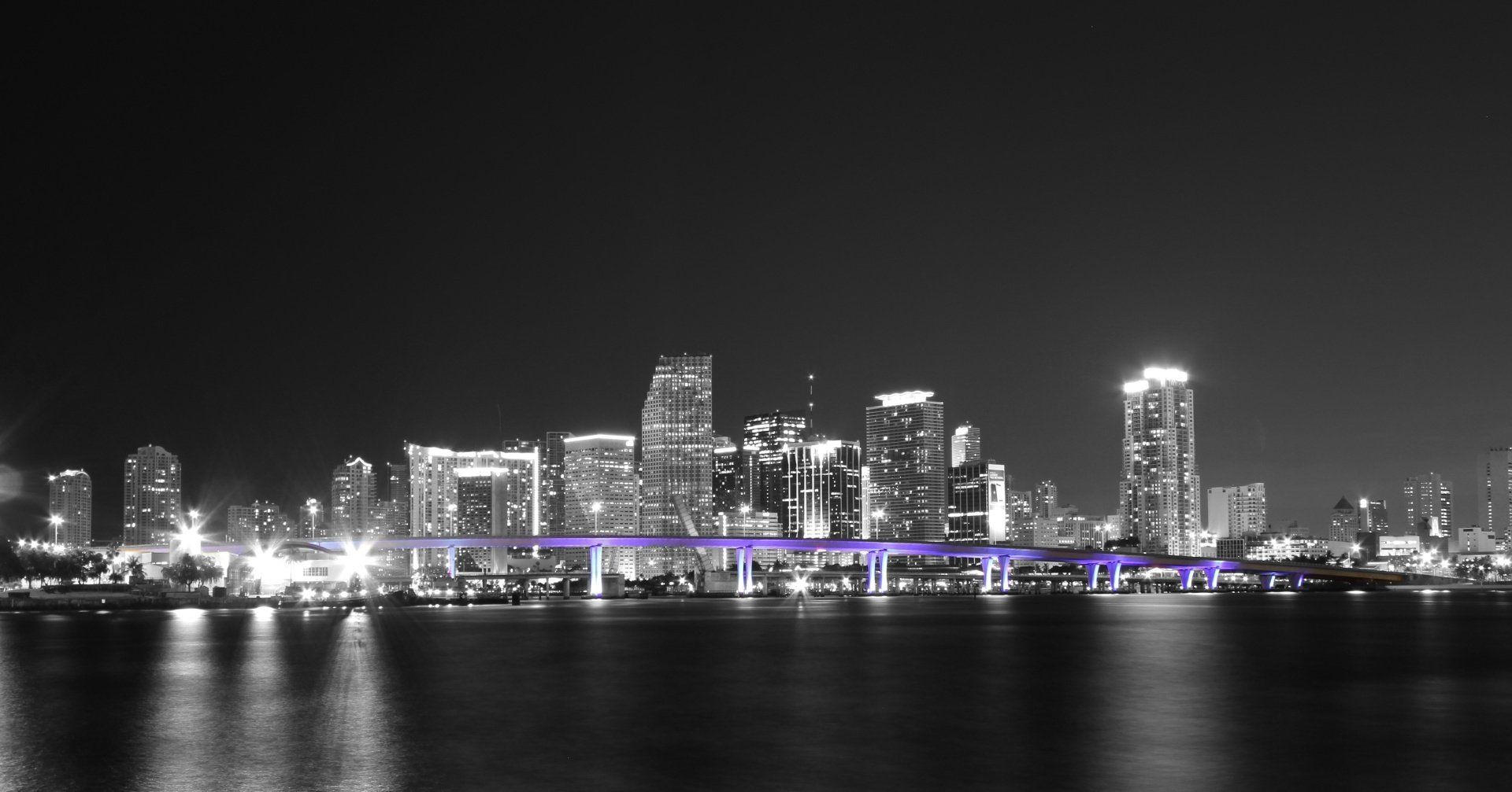 a black and white photo of a city skyline at night