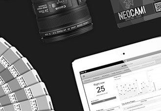 a black and white photo of a camera , a tablet , and a neocami card .