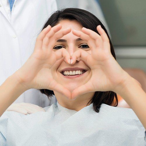 Woman holding up heart sign