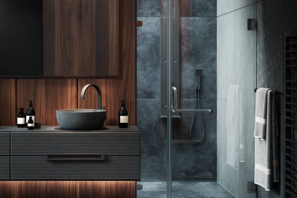 A bathroom with a sink , mirror , and walk in shower.