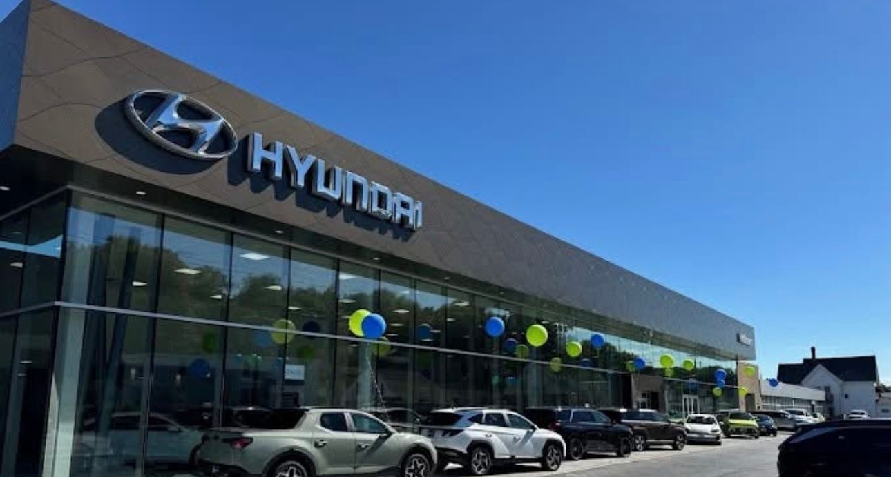 Hyundai dealership building with cars parked outside on a sunny day.