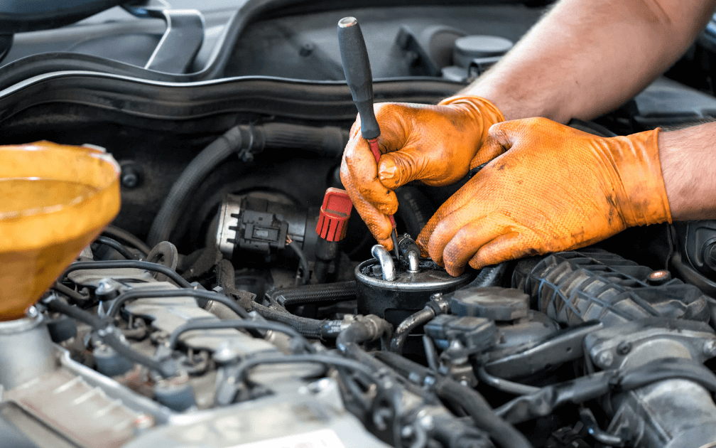 An image of a mechanic doing an auto repair. 