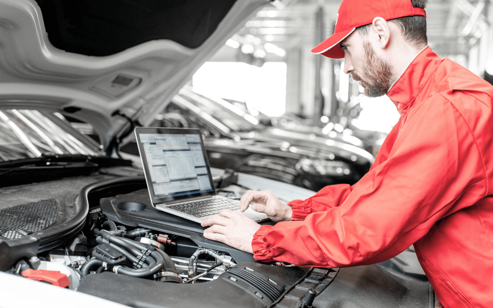 An image of a mechanic doing a vehicle diagnostic.