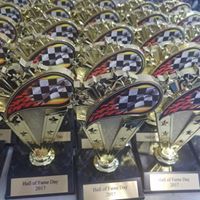 A bunch of trophies are sitting on top of each other on a table.