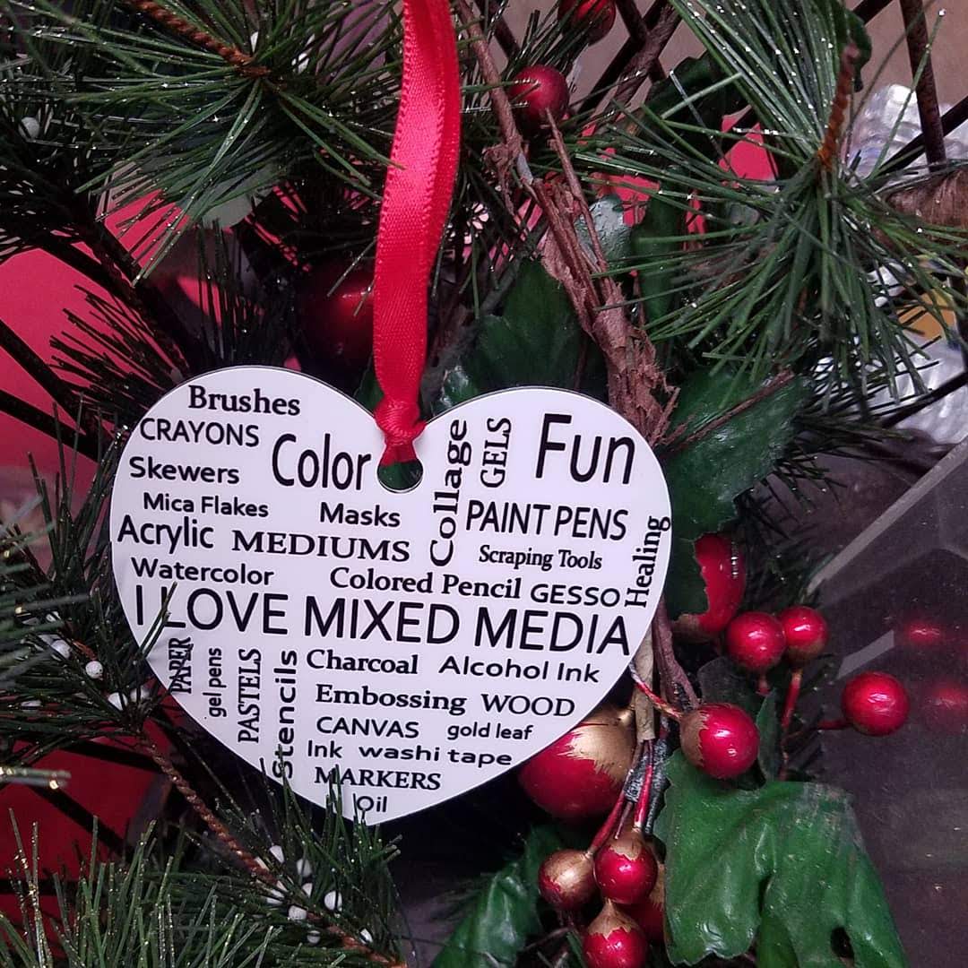 A heart shaped ornament that says i love mixed media