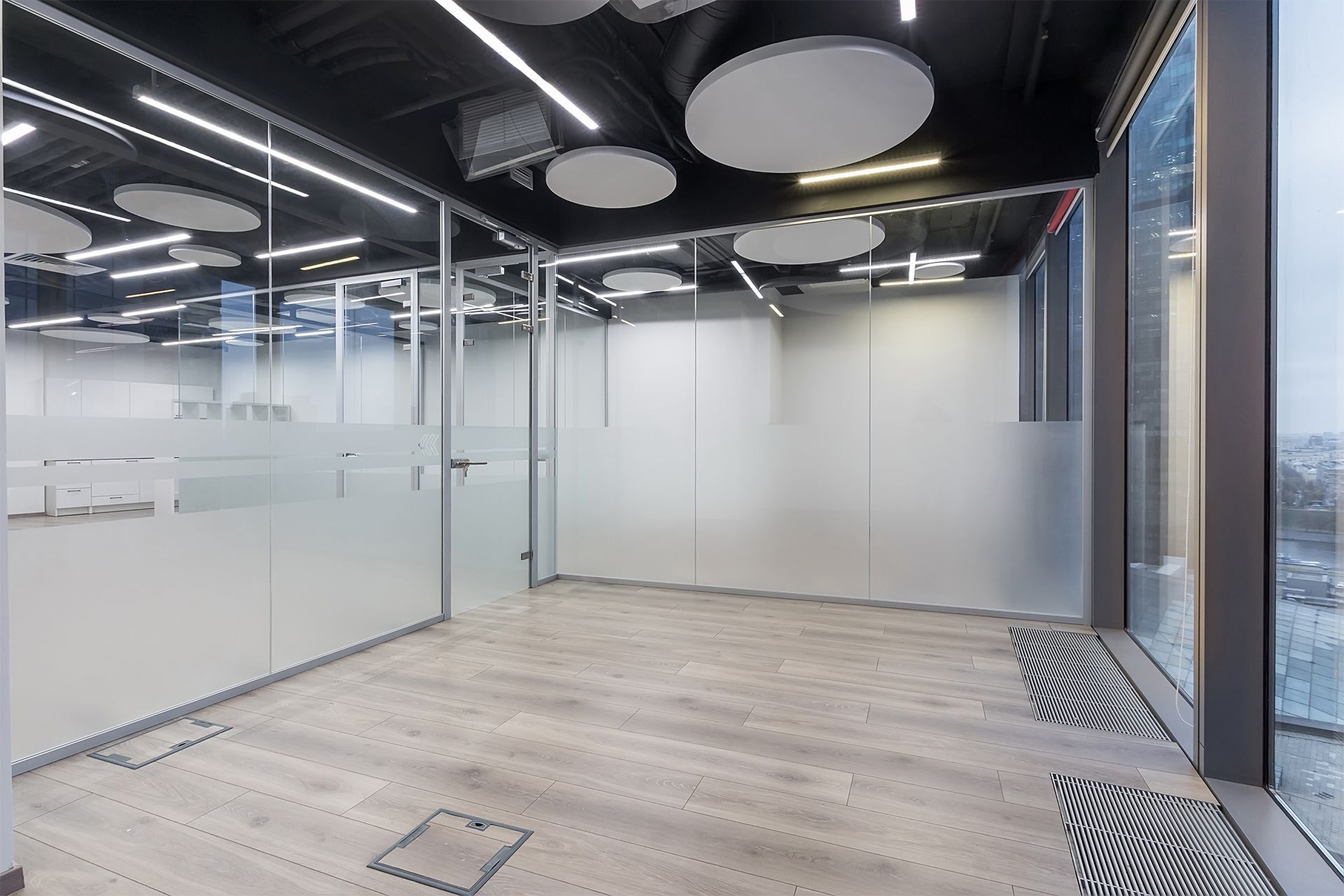An empty room with a lot of windows and a wooden floor