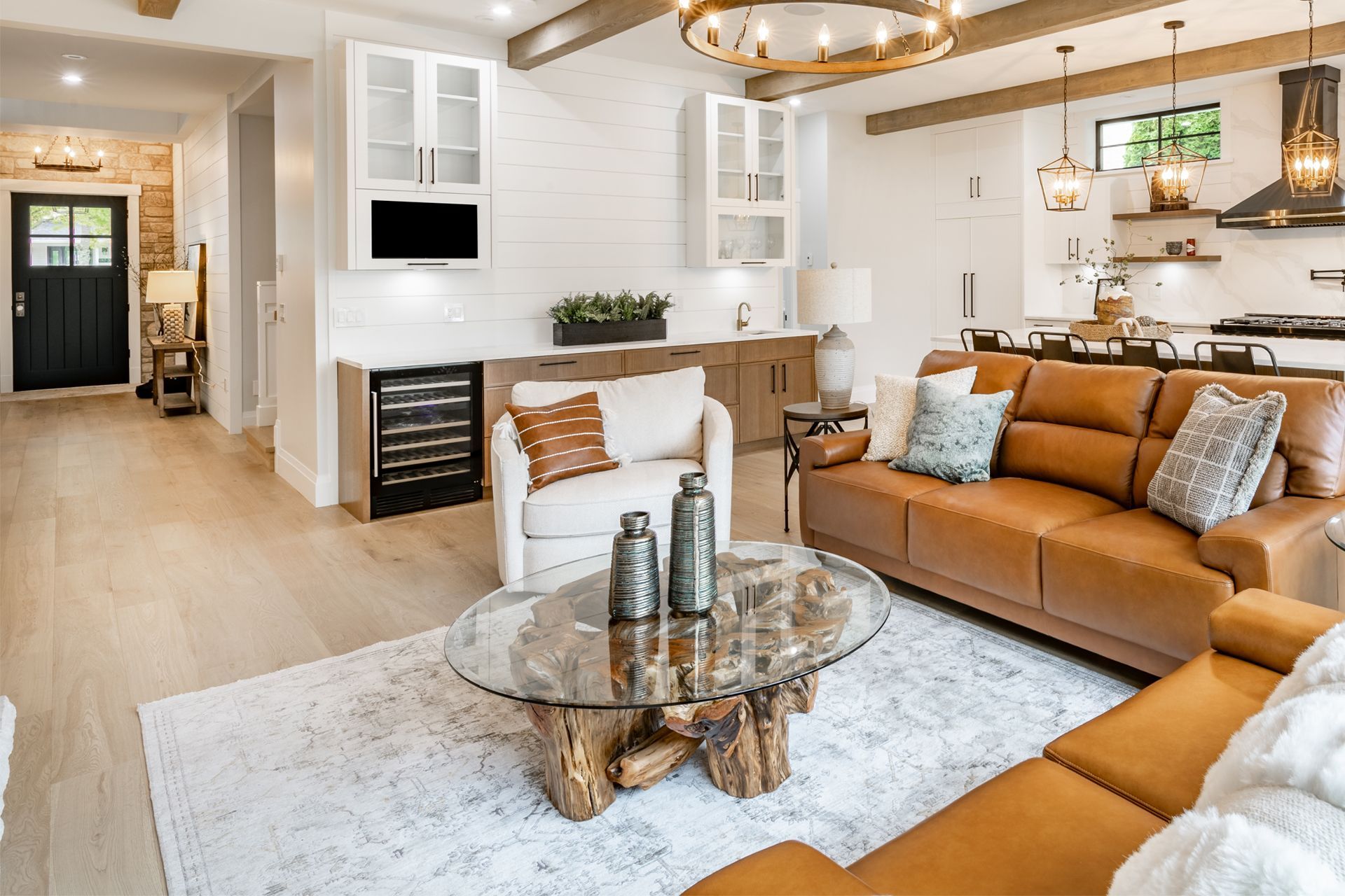 A living room with a brown couch and a glass coffee table