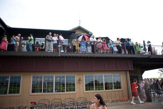 A group of people are standing on the roof of a building.