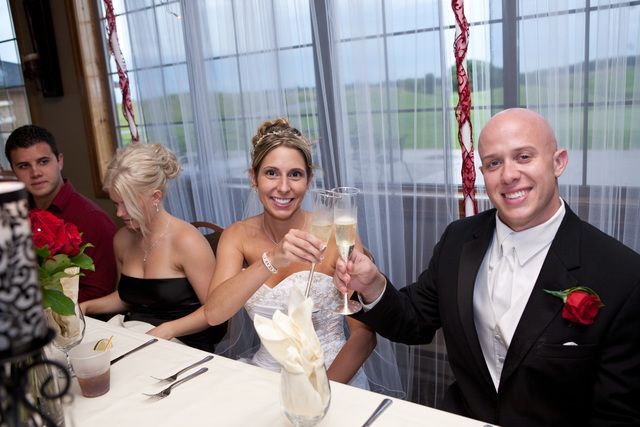 A bride and groom toasting with champagne at their wedding reception