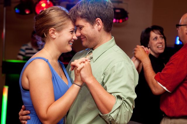 A man and a woman are dancing together at a party.