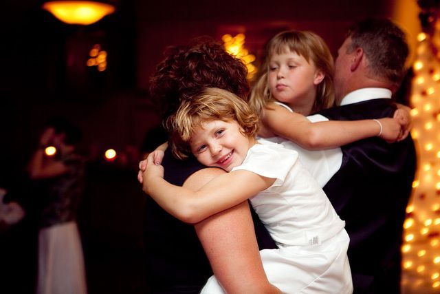 A woman is holding a little girl in her arms