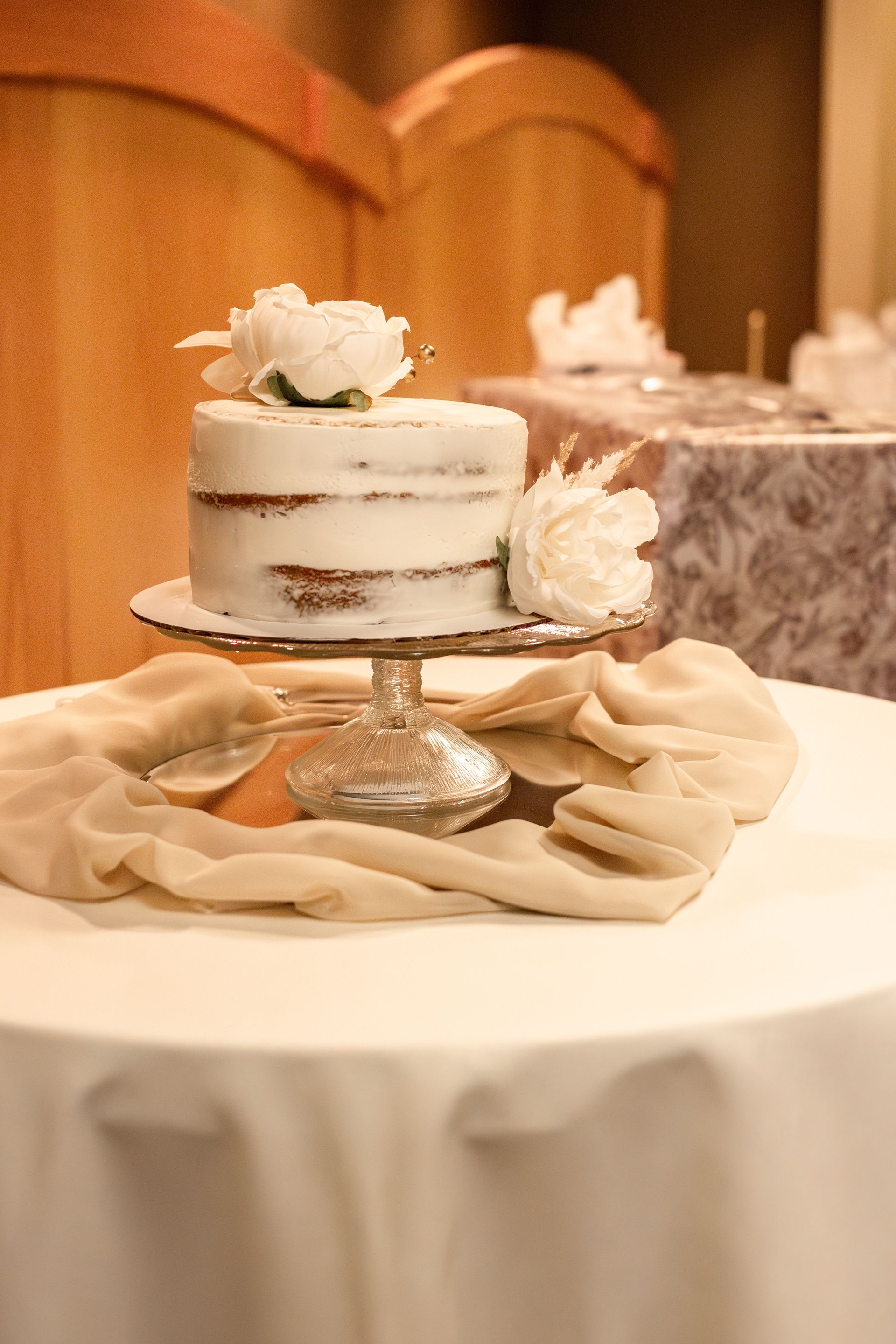 A wedding cake is sitting on top of a table.