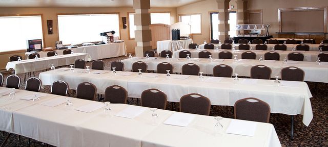 A conference room with long tables and chairs set up for a meeting.