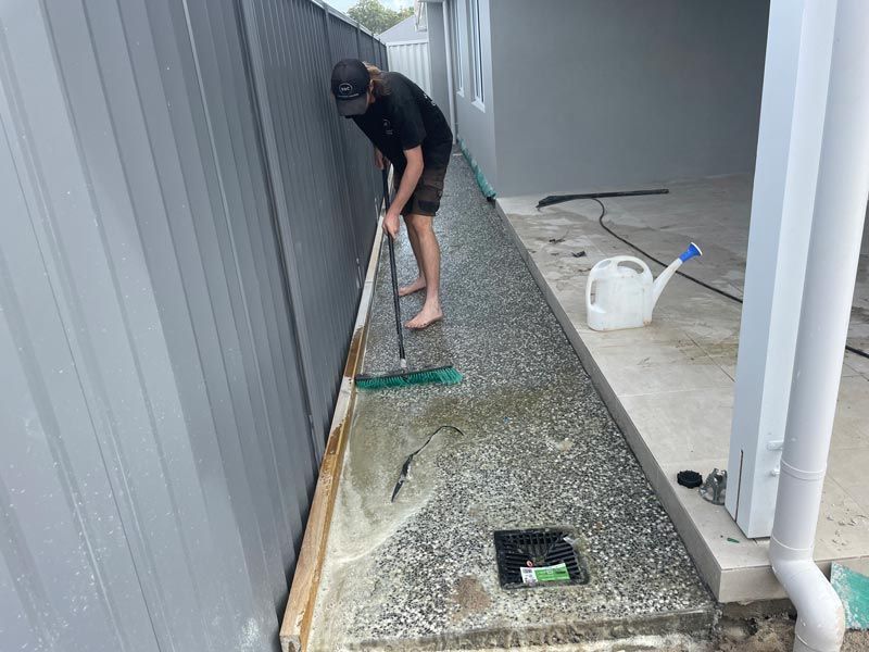 Washing Off Dirt on Pebble Concrete — Brodie Wynter Concreting in Port Macquarie, NSW