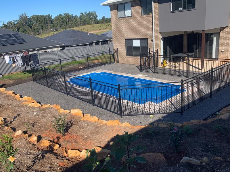 Backyard Pool with Fence — Brodie Wynter Concreting in Port Macquarie, NSW