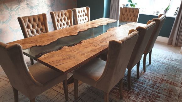 Burr oak dining river table with teal coloured resin pigments.