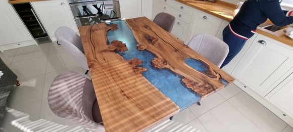 Character elm river table with light blue and silver resin.