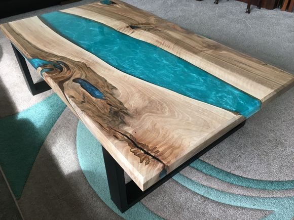 A walnut river coffee table with turquoise resin.