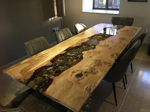 Oak table with a beach pebble resin river.